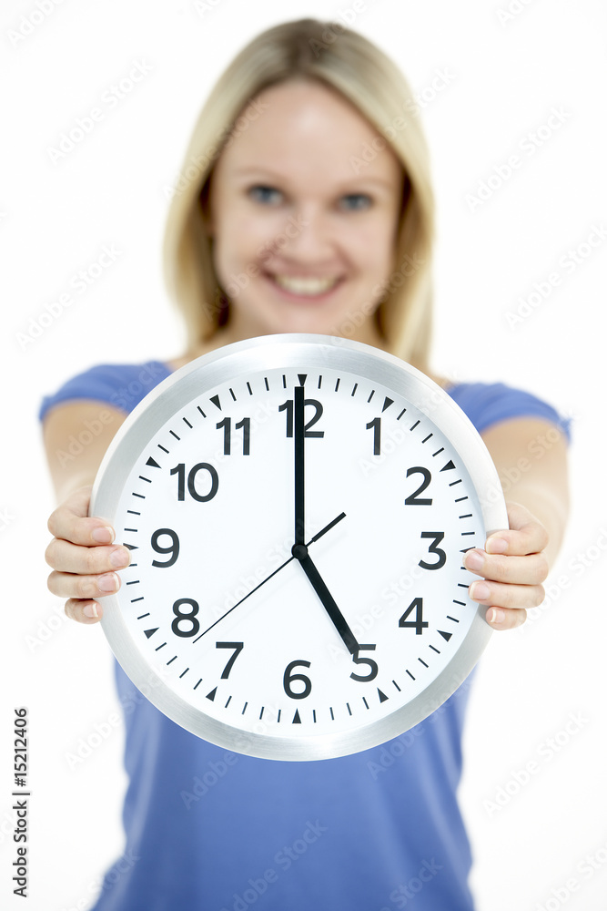 Woman Holding Clock Showing 5 O'Clock Woman Holding Clock Showing 5 O'Clock