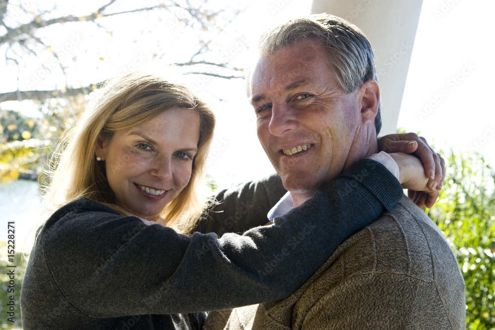 Fototapeta premium Portrait of smiling mature couple embracing outdoors