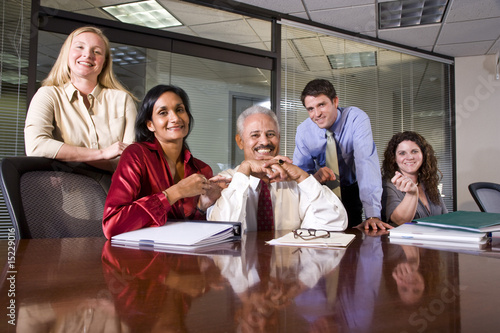 Five multi-ethnic colleagues in an office conference room