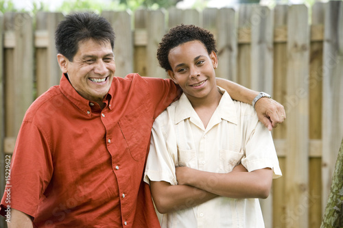 African teenage boy with proud Hispanic father