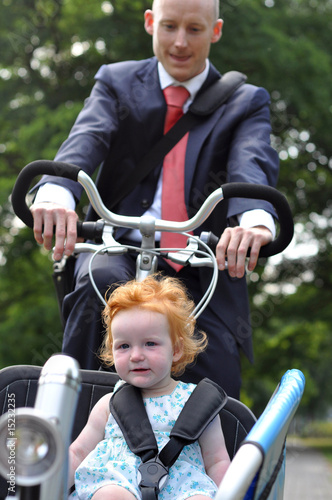Business men riding his young child to creche