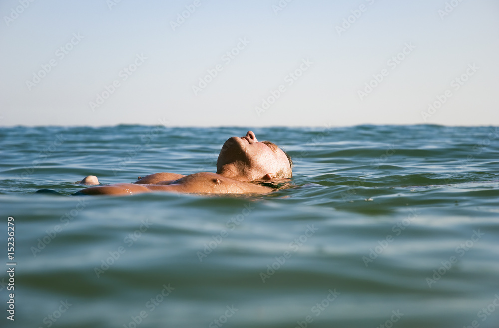 Fototapeta premium man floating on water