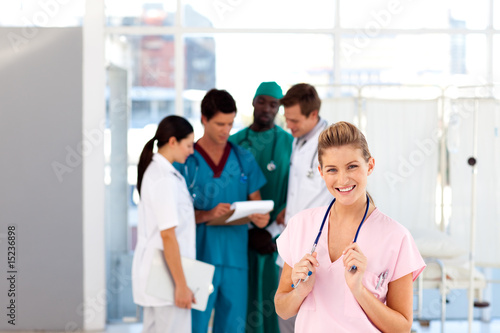 Young nurse with her team in the background