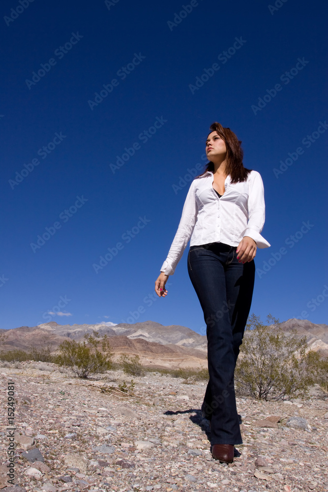 Woman walking in open desert
