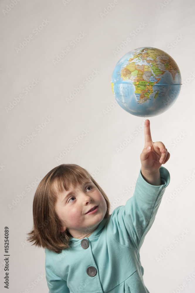young girl about to touch a globe young girl about to touch a globe