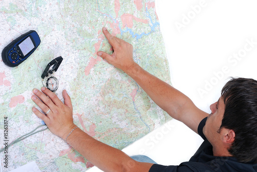 Man sitting and looking at maps in his hands