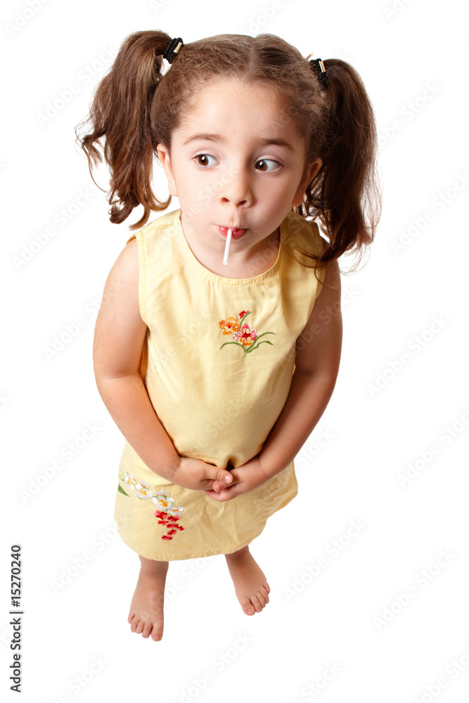 Cute girl sucking on a lollipop candy Cute girl sucking on a lollipop candy