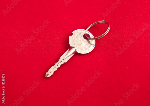 Silver key on a red background