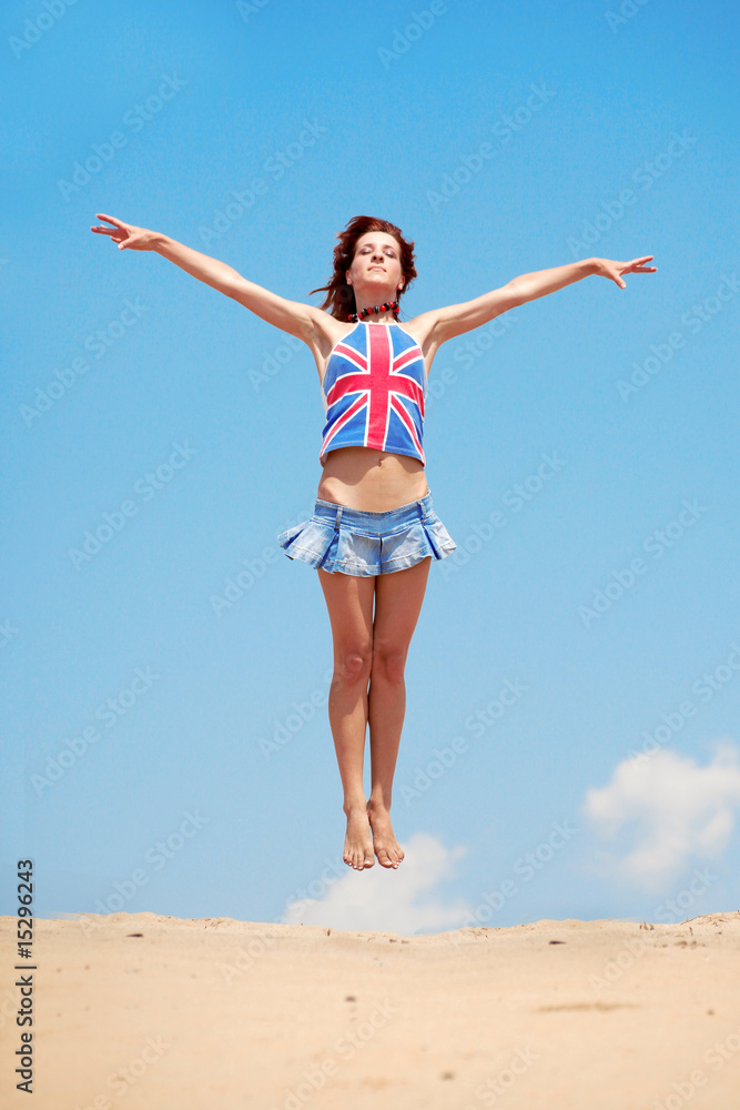 Young girl jumping on a background of blue sky Young girl jumping on a background of blue sky