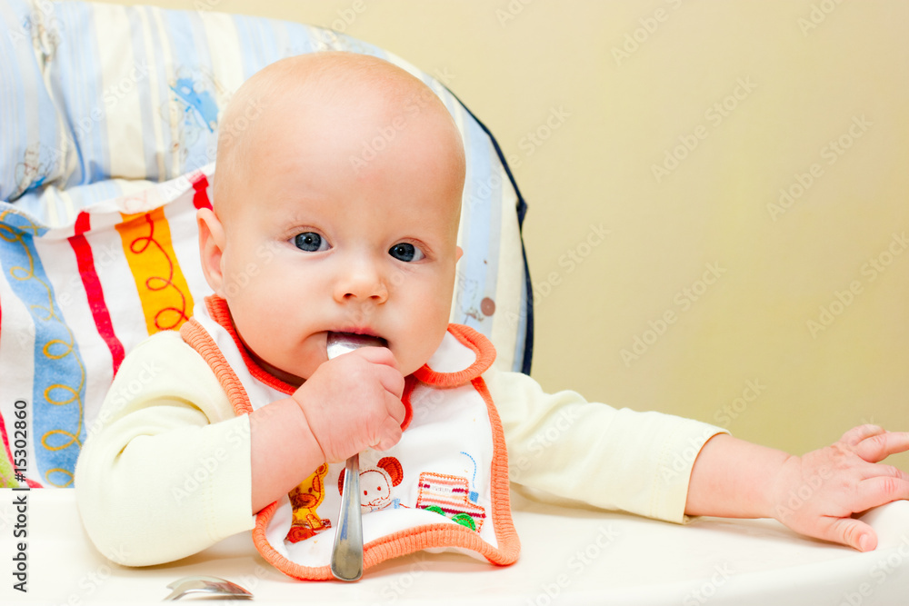 Infant with spoon