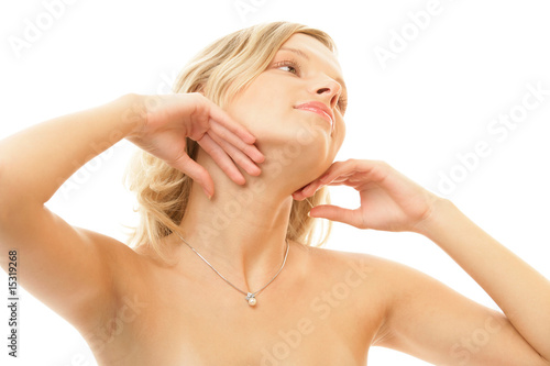 Portrait of young blonde woman touching face