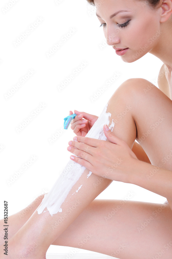 pretty young woman shaving legs with razor pretty young woman shaving legs with razor