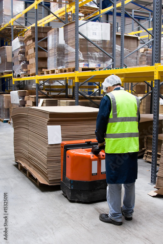 worker with fork-lift in warehouse