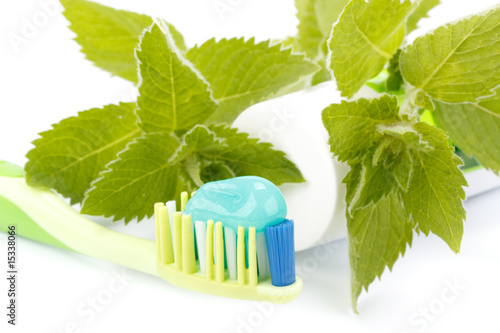 Toothbrush  toothpaste and fresh leaves of mint