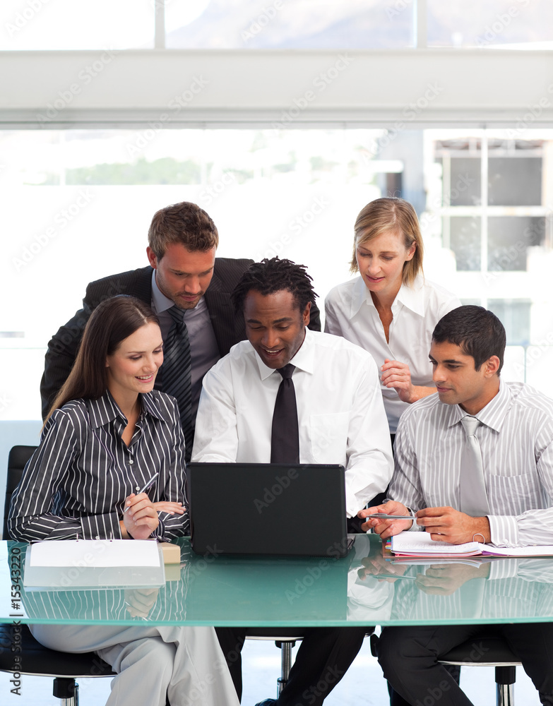 Business people using a laptop together Business people using a laptop together