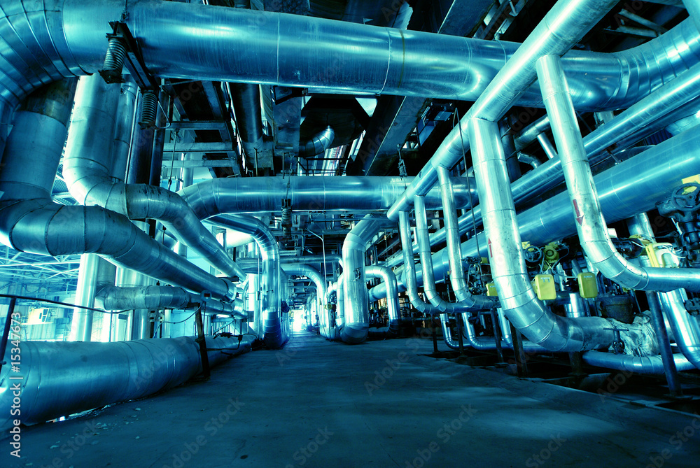 Pipes, tubes, machinery and steam turbine at a power plant Pipes, tubes, machinery and steam turbine at a power plant