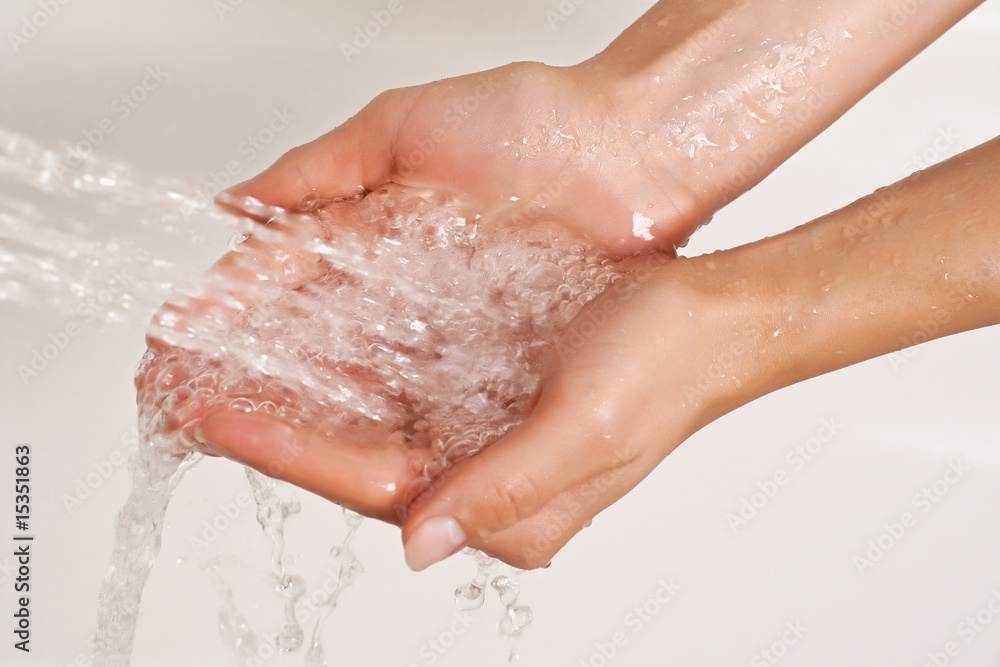 Hands under a stream of shower