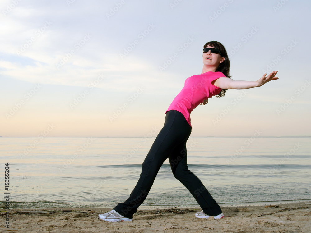 Exercising on the beach at sunset Exercising on the beach at sunset