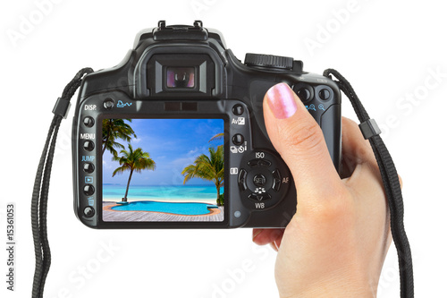 Camera in hand and beach landscape