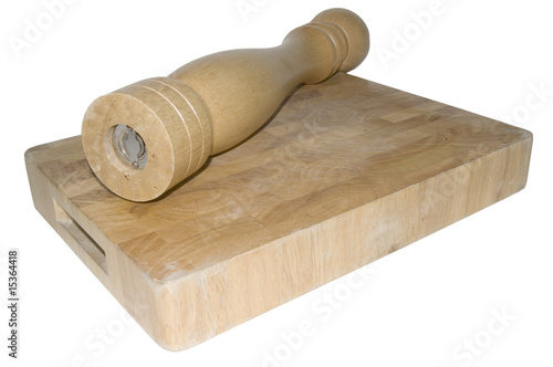 pepper mill on chopping board on white background