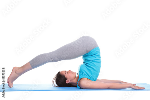 Woman lying on a mat doing yoga photo