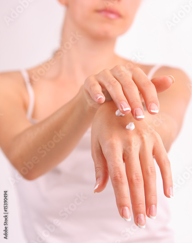 Woman puts a cream for beautiful hands