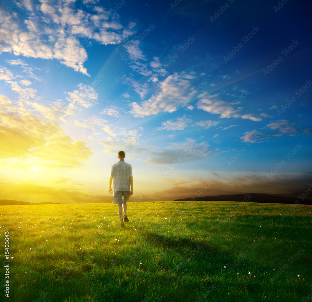 one man and field of spring grass one man and field of spring grass