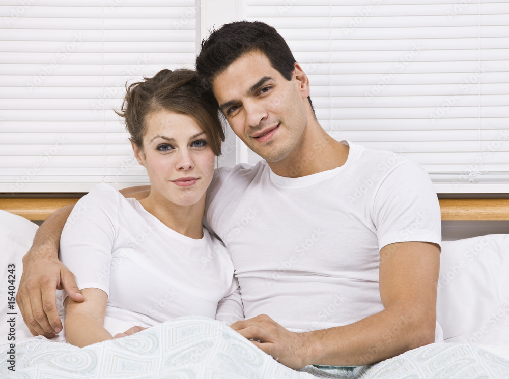 Fototapeta premium Attractive couple in bed together