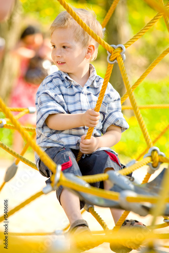 Boy sitting on yellow ropes