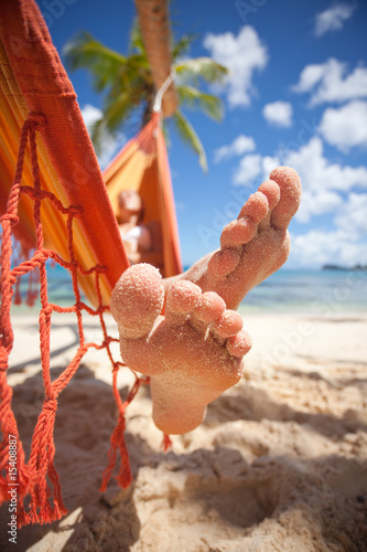 sandy toes of woman in hammock