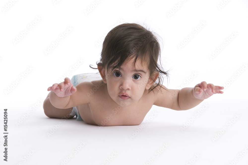 Baby girl lying on her belly hands up Baby girl lying on her belly hands up