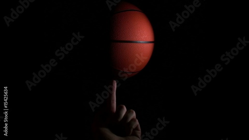Basketball spins on figer against black slow - HD