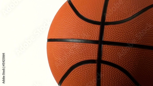 Basketball rotates against white with copy space - HD photo