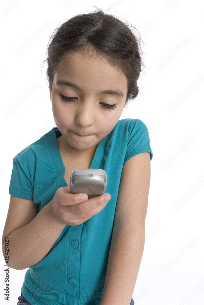 Little girl is reading a text message on her mobile phone Little girl is reading a text message on her mobile phone