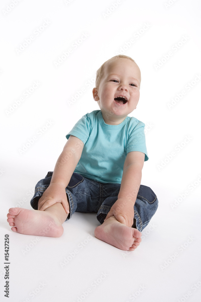 Toddler boy sitting on the floor having fun Toddler boy sitting on the floor having fun