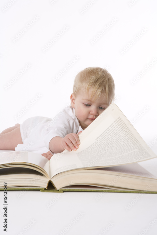 Little girl pretends to read a large book Little girl pretends to read a large book