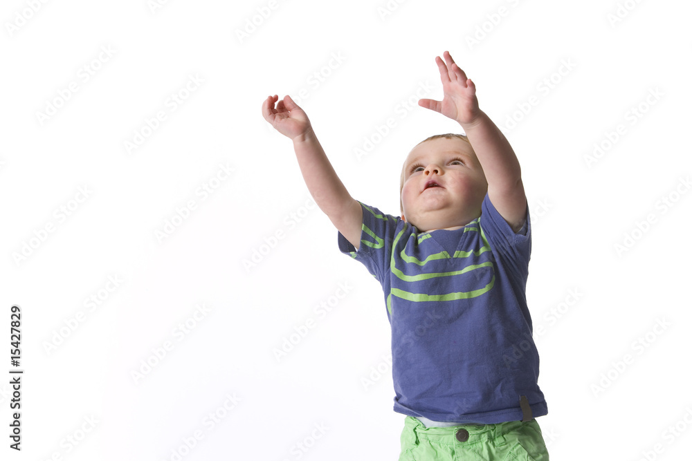 Little boy is trying to reach out with two hands Little boy is trying to reach out with two hands
