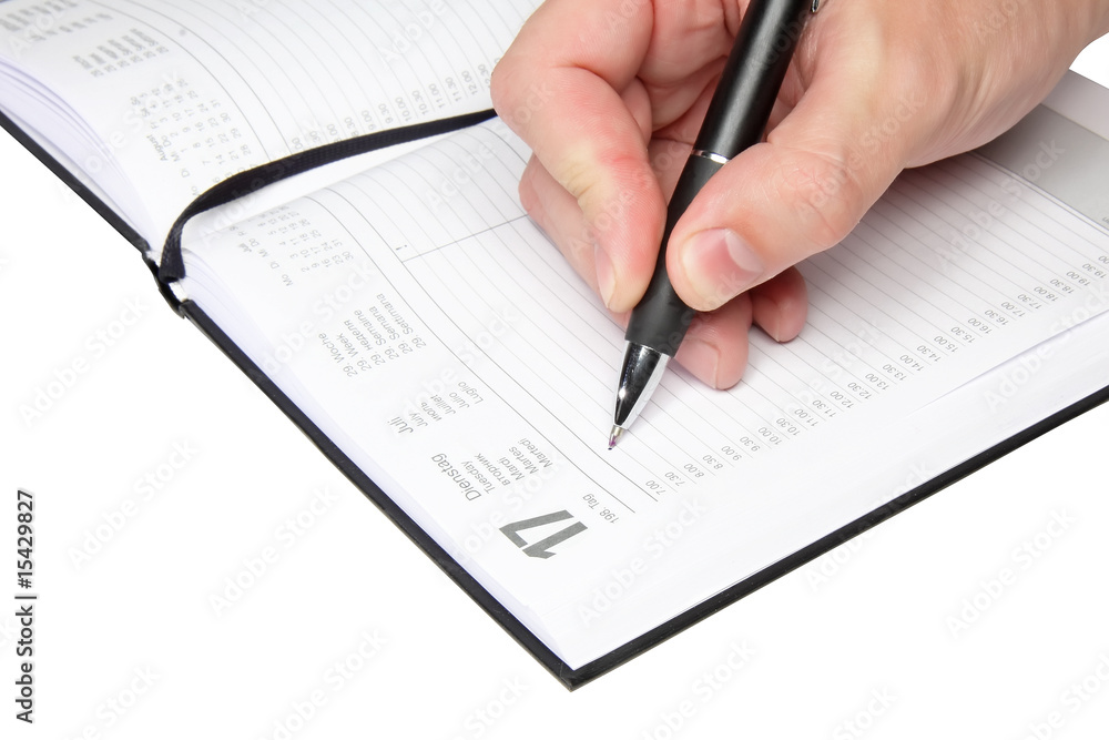 Daily personal organizer with writting hand. Isolated Daily personal organizer with writting hand. Isolated