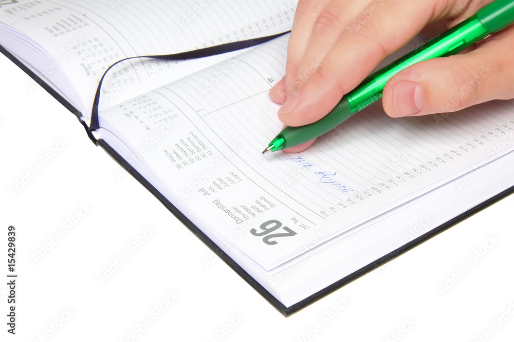 Daily personal organizer with writting hand. Isolated Daily personal organizer with writting hand. Isolated