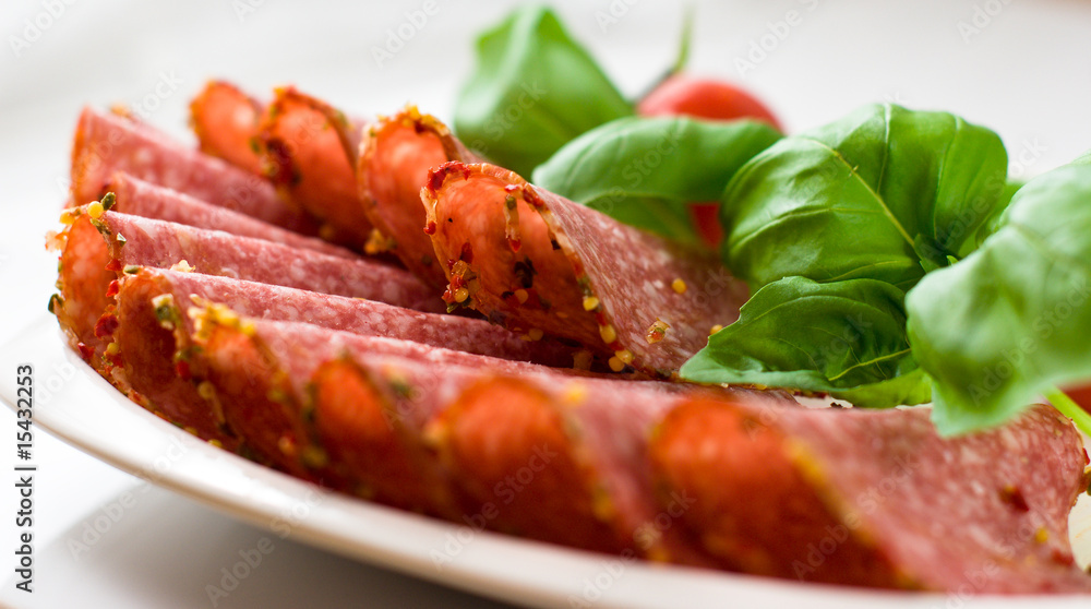 Sliced salami with basil Sliced salami with basil