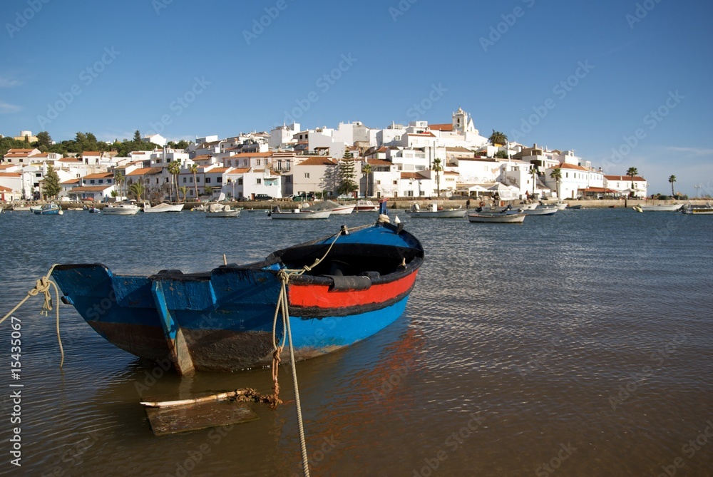 Fishing boat with Ferragudo village in the background.
