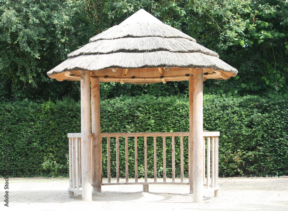 Naklejka premium A Thatched Roof Outdoors Children's Play Shelter.