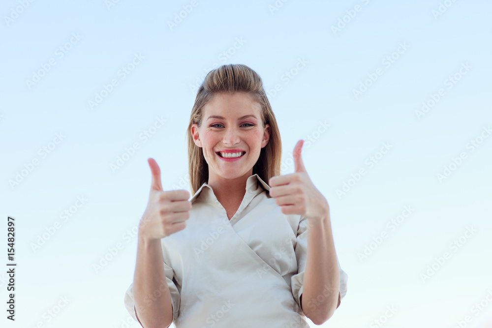 Businesswoman smiling at the camera with thumbs up Businesswoman smiling at the camera with thumbs up