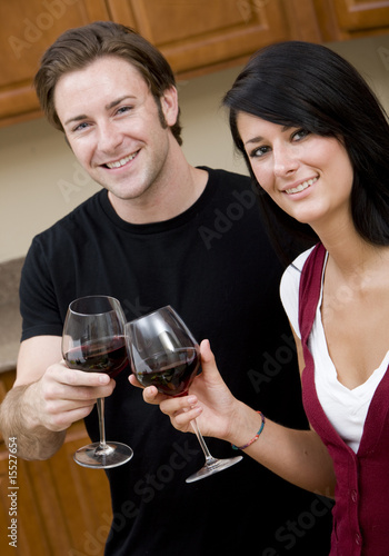 A young couple enjoying a glass of wine