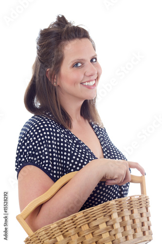 Young woman in a dress carrying a wicker basket; isolated