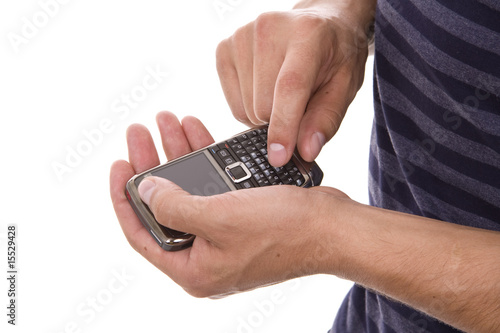 Young casual man using cellphone isolated on whithe
