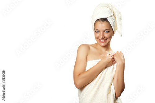 woman after shower with towel with hands near shoulder