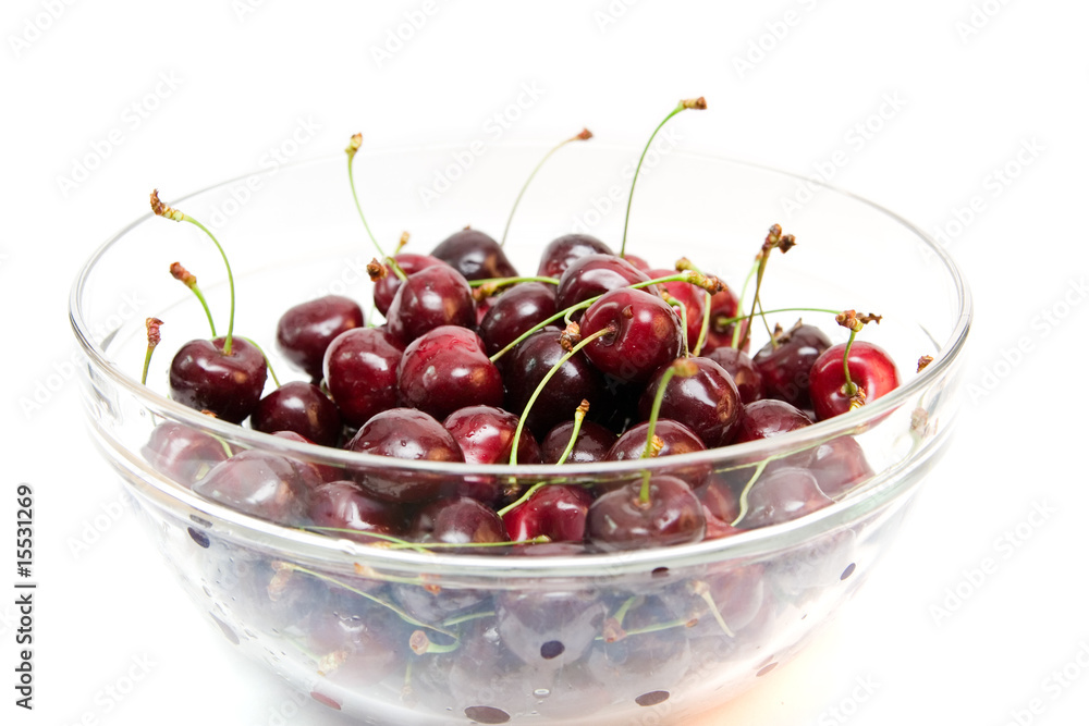 red cherries in a bowl isolated on white
