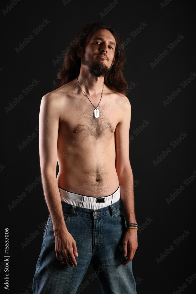 Rebel with long hair and topless slim body isolated on black Stock Photo |  Adobe Stock