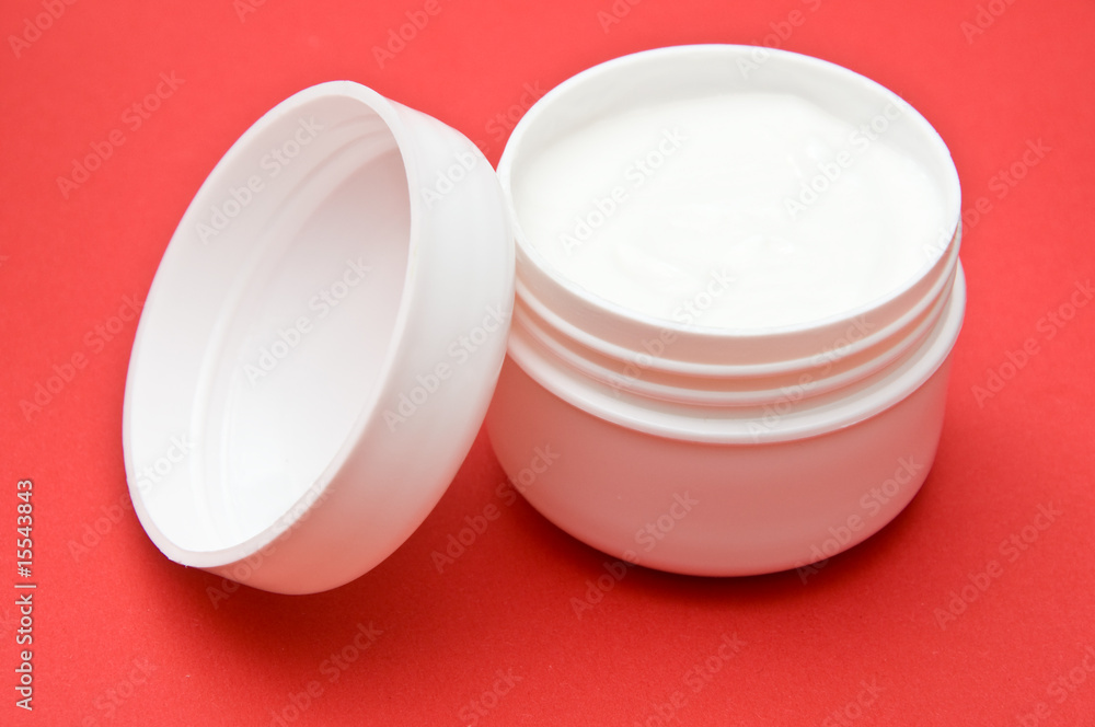 Plastic creme holder on red background Plastic creme holder on red background